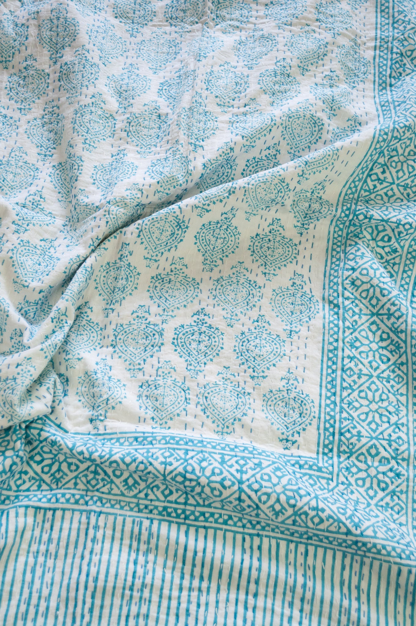 Aqua blue on white Mughal motif blockprint kantha quilt.