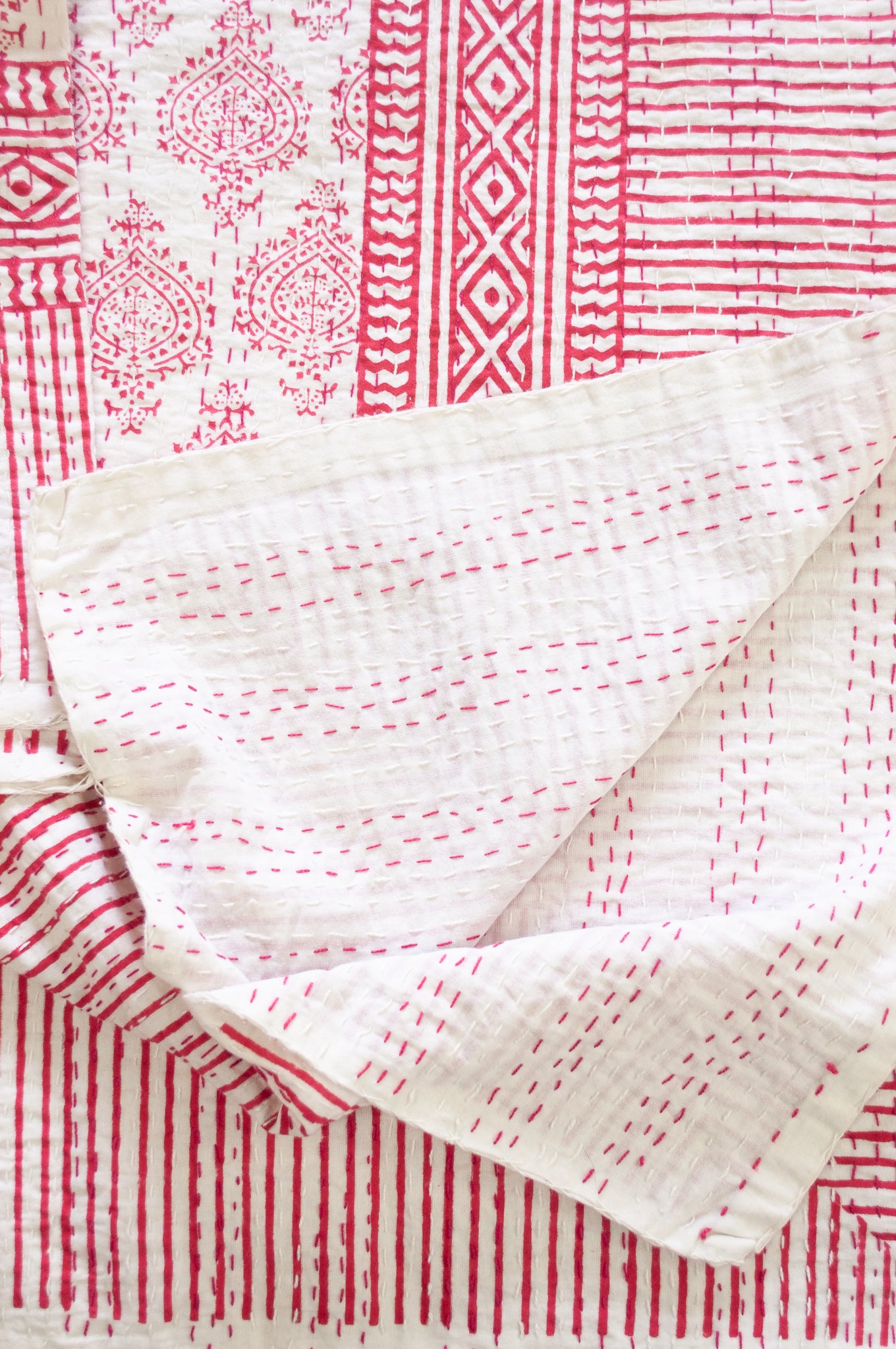 Raspberry red on white Mughal motif blockprint kantha quilt.