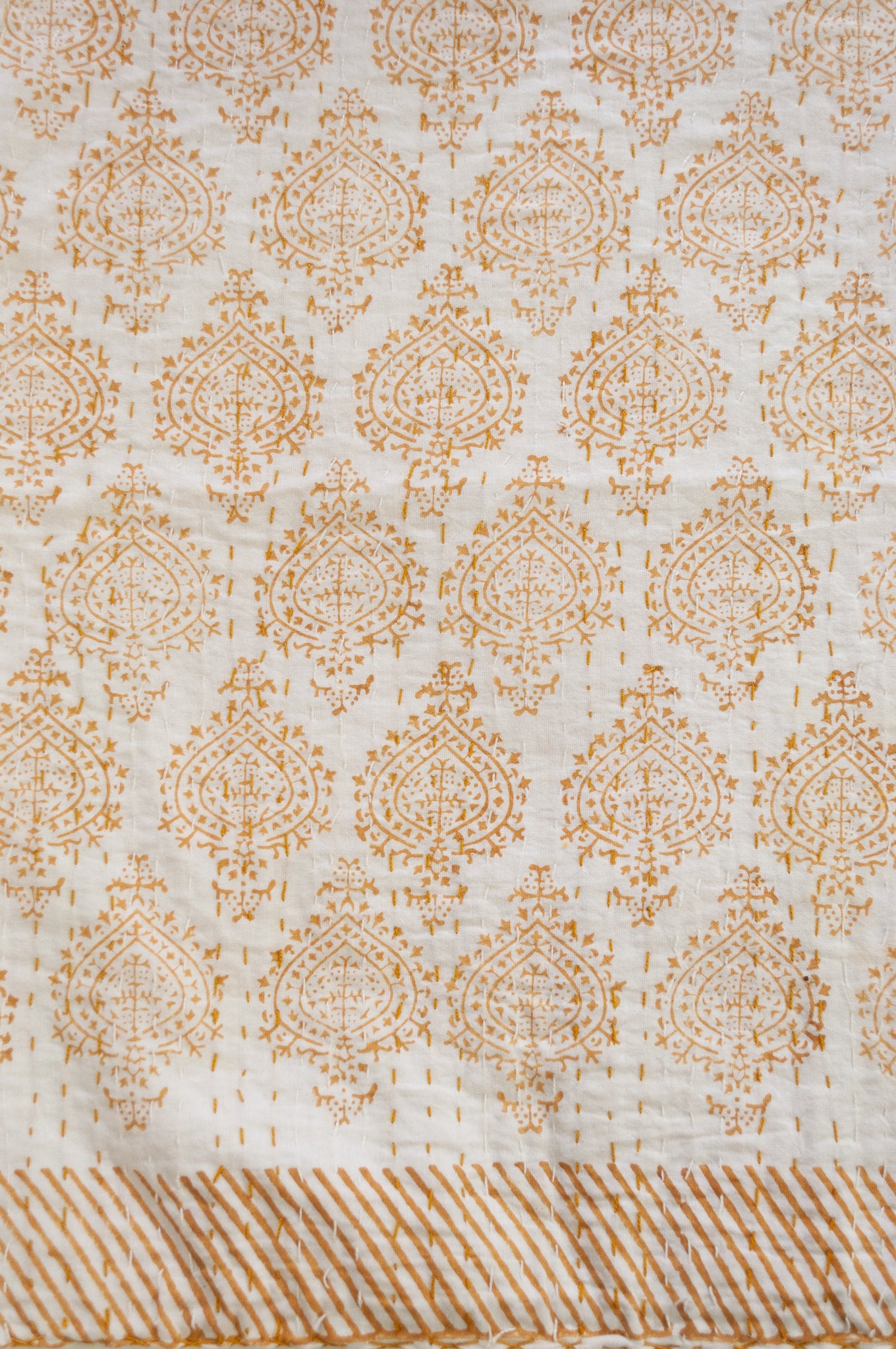 Mustard yellow on white Mughal motif blockprint kantha quilt.