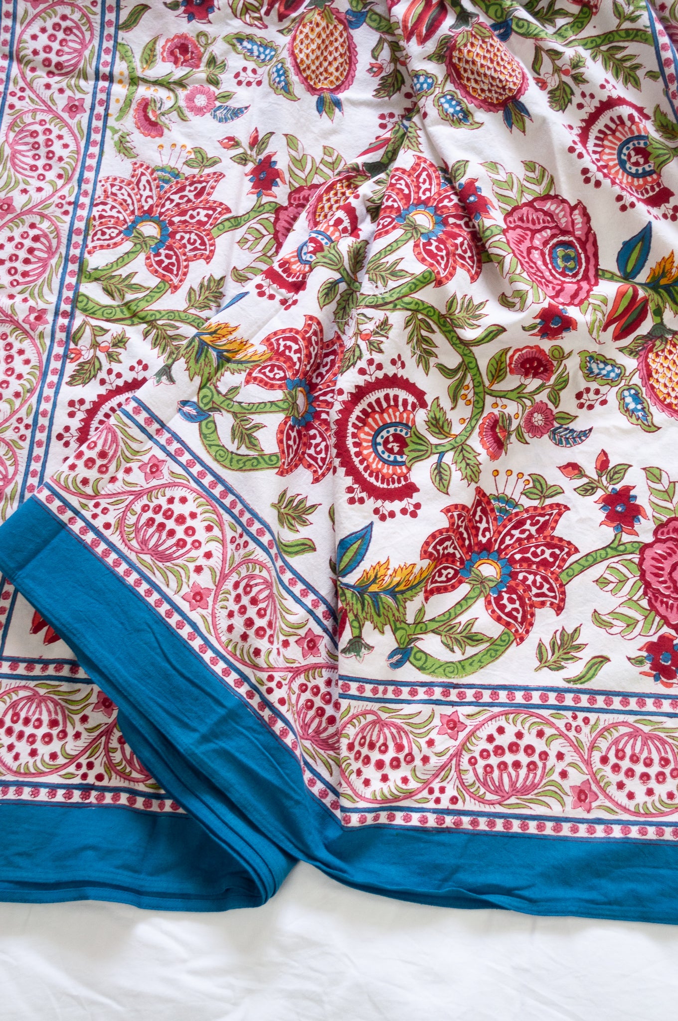 Floral blockprint large table cloth bedcover with pomegranates in pinks, red, blue and green.