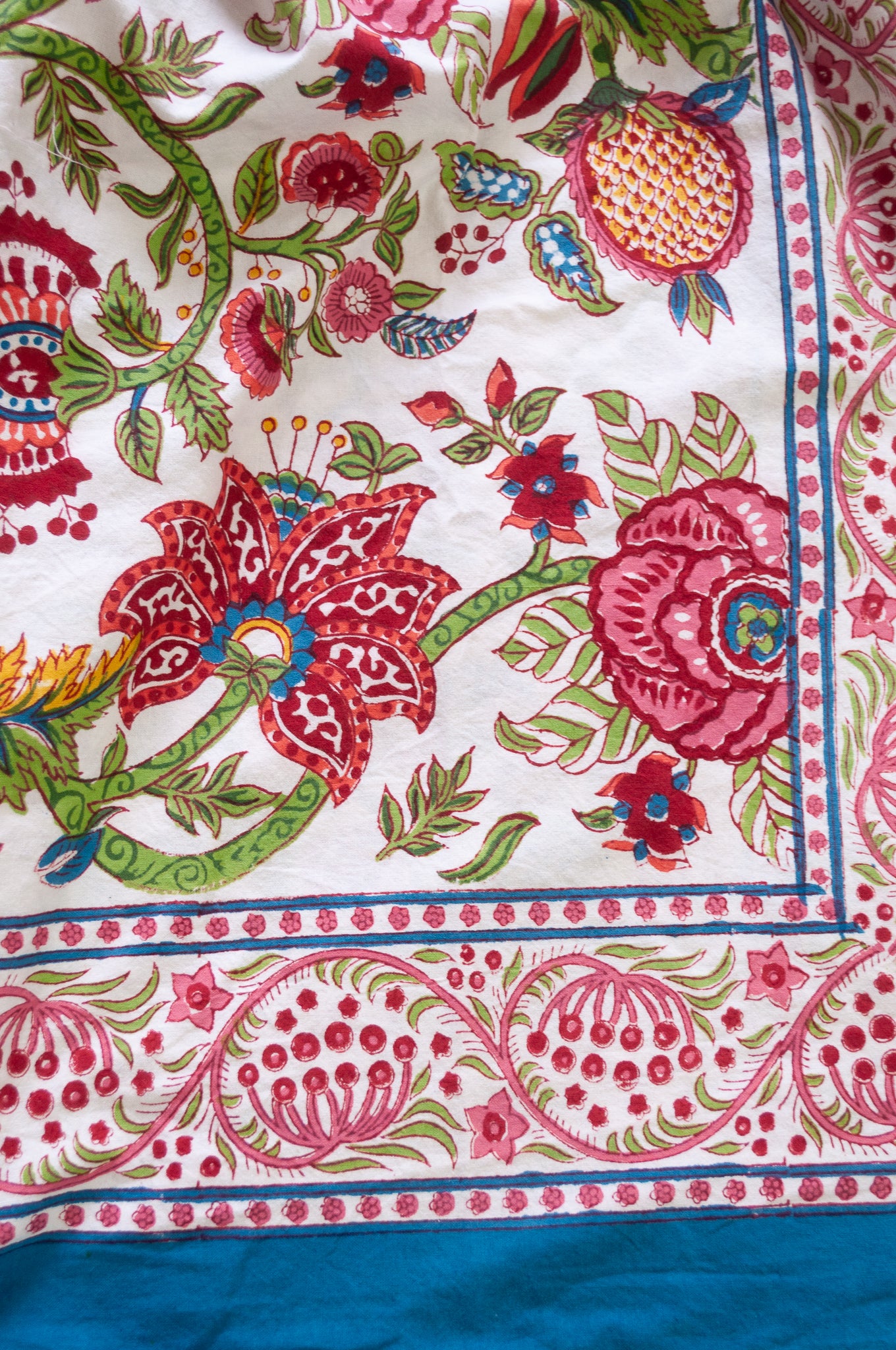 Floral blockprint large table cloth bedcover with pomegranates in pinks, red, blue and green.