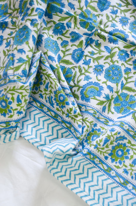 Floral blockprint cotton table cloth in shadews of aqua blue, and lime green on white.