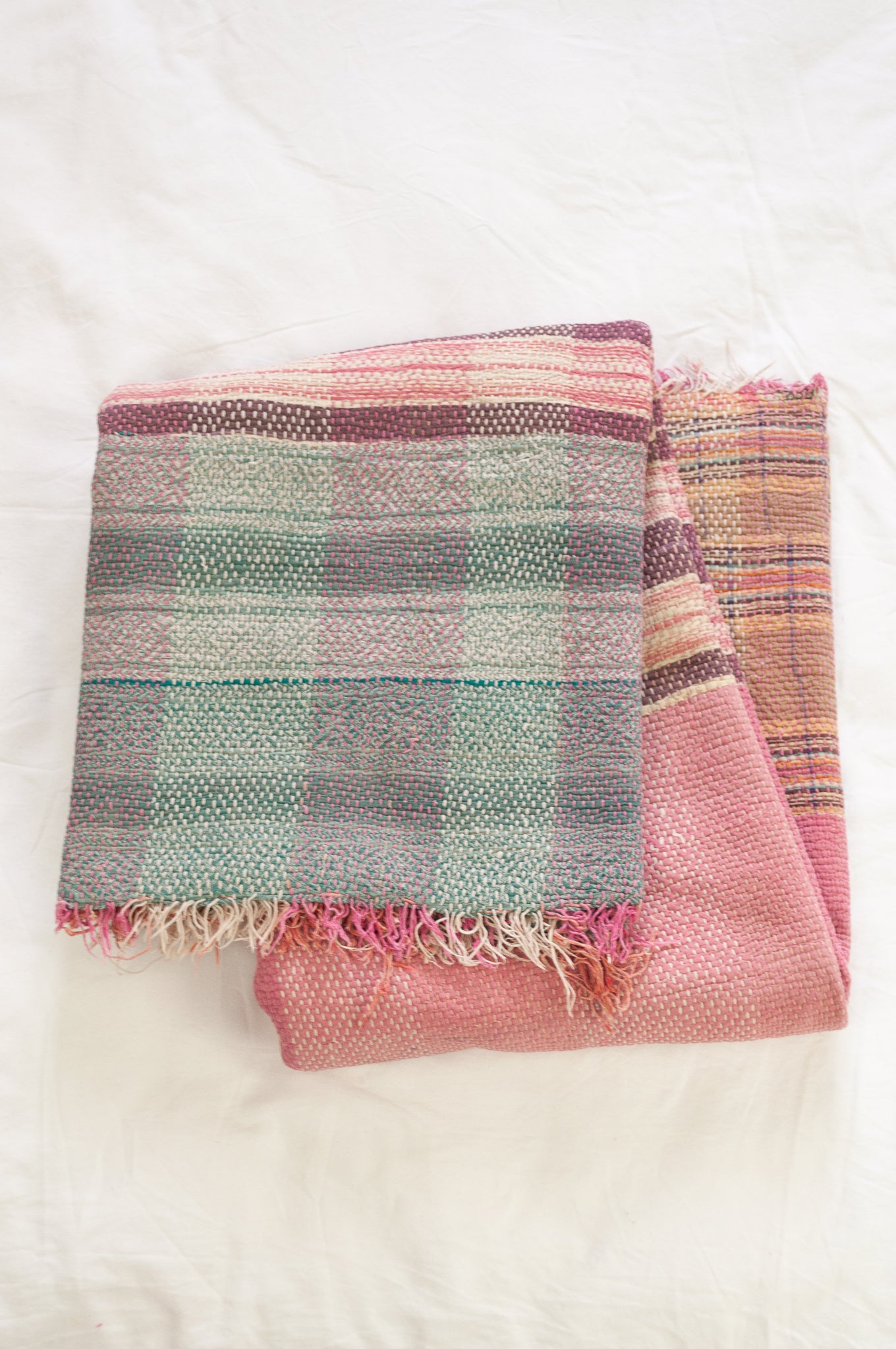 Vintage kantha quilt in pastel stripes and checks, with pattern  in pink, lavender and mint.