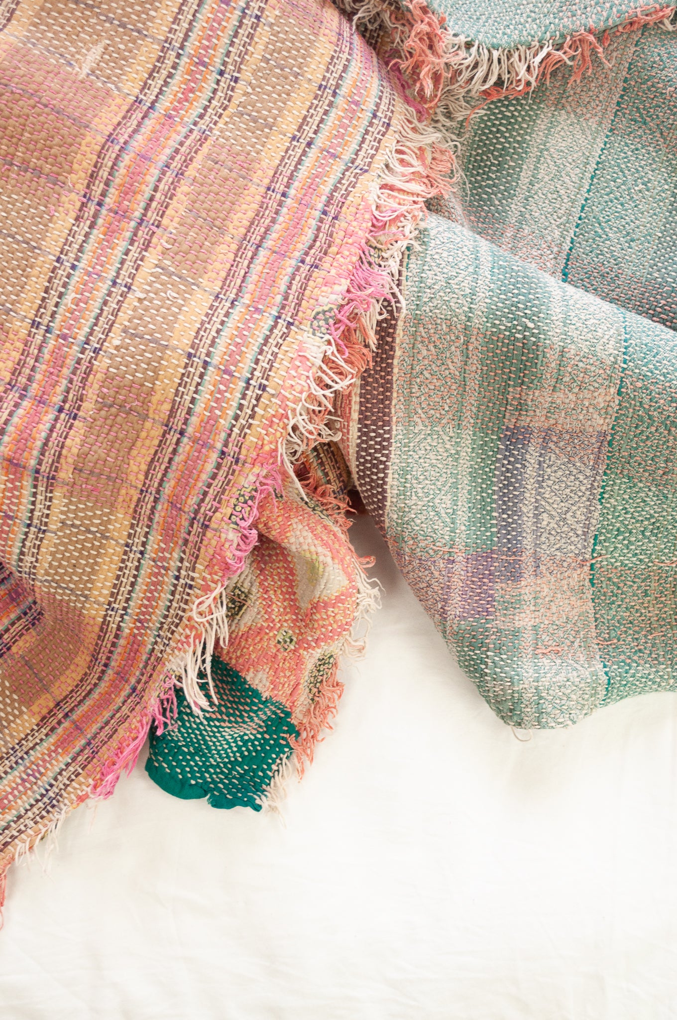Vintage kantha quilt in pastel stripes and checks, with pattern  in pink, lavender and mint.