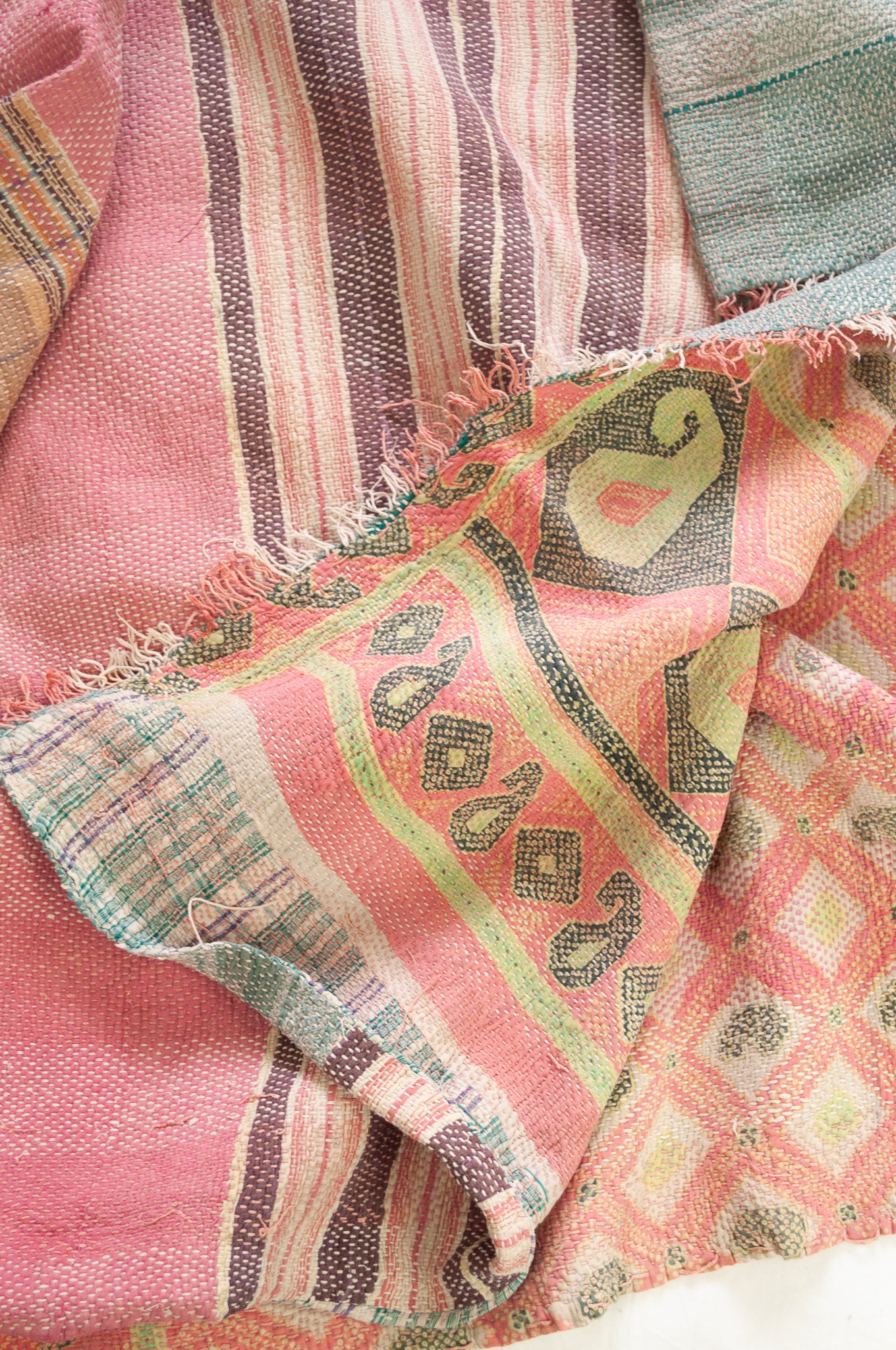 Vintage kantha quilt in pastel stripes and checks, with pattern  in pink, lavender and mint.