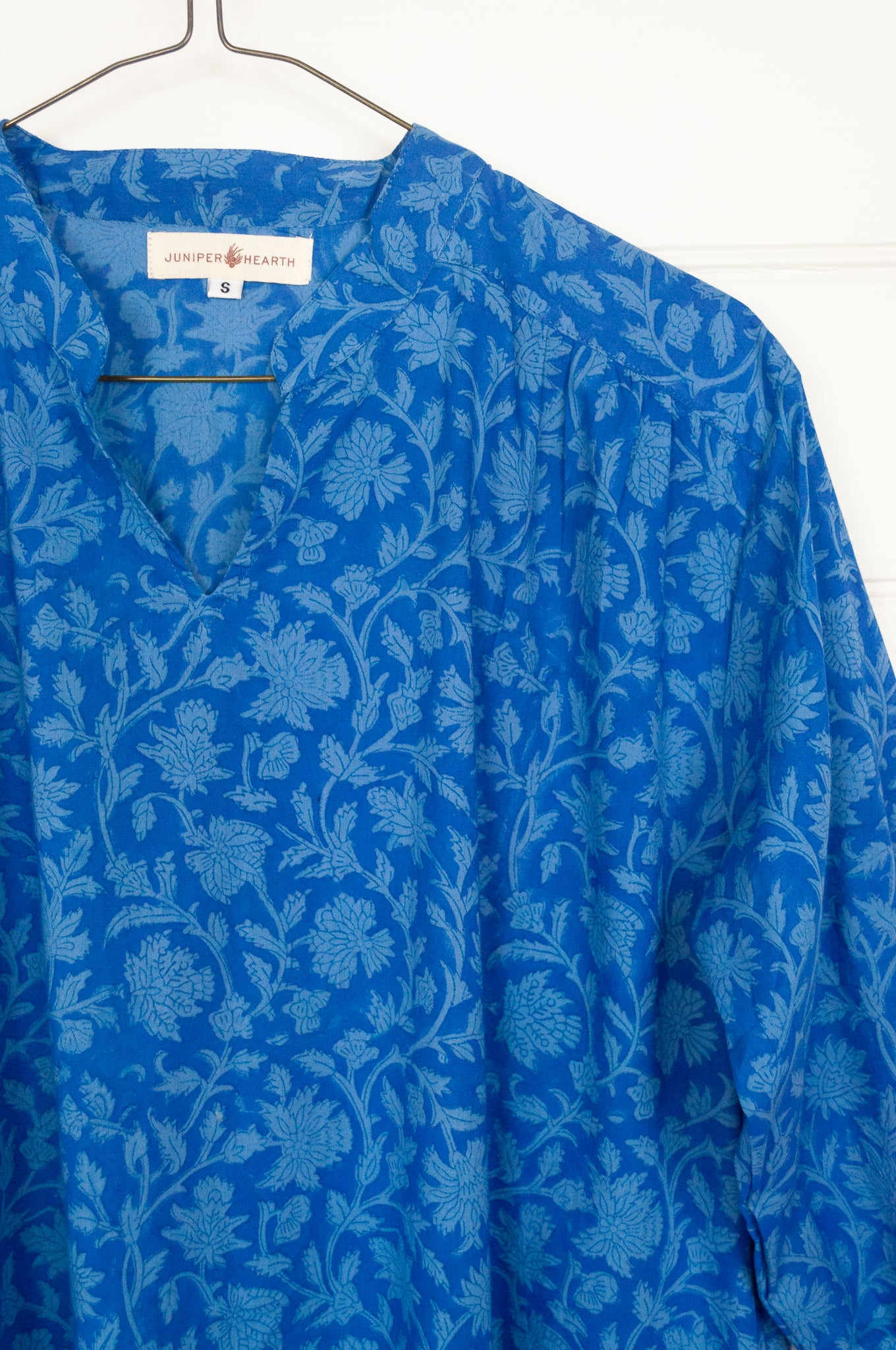 Juniper Hearth Gina dress in cornflower blue floral blockprint in organic cotton, flowy style with three quarter sleeves and deep frill skirt.