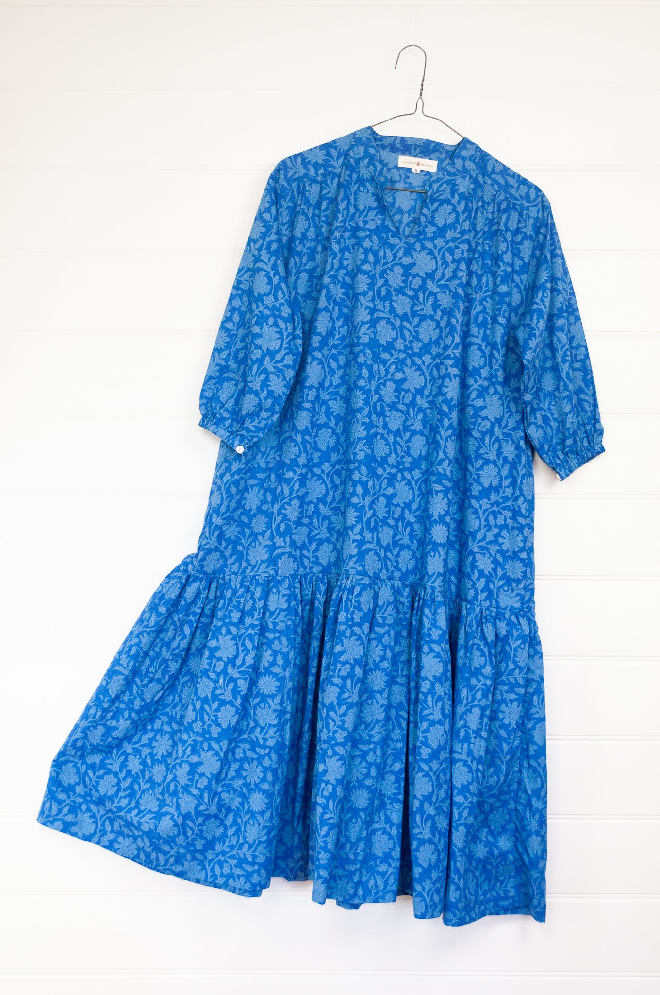 Juniper Hearth Gina dress in cornflower blue floral blockprint in organic cotton, flowy style with three quarter sleeves and deep frill skirt.