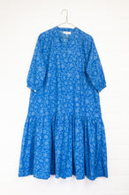 Load image into Gallery viewer, Juniper Hearth Gina dress in cornflower blue floral blockprint in organic cotton, flowy style with three quarter sleeves and deep frill skirt.