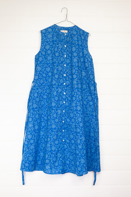 Juniper hearth Zoe dress button up sleeveless with waist ties, made from cotton cornflower blue blockprint floral.