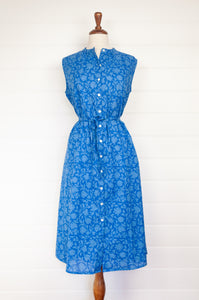 Juniper hearth Zoe dress button up sleeveless with waist ties, made from cotton cornflower blue blockprint floral.