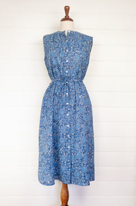 Juniper hearth Zoe dress button up sleeveless with waist ties, made from cotton blue grey blockprint floral.
