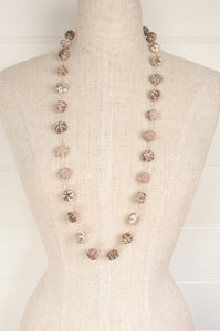 Sophie Digard hand made embroidered linen beads in neutral tones.