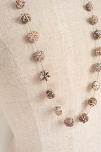 Sophie Digard hand made embroidered linen beads in neutral tones.