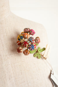 Sophie Digard handmade linen flower brooch in warm colours.