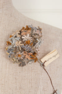 Sophie Digard floral brooch, hand embroidered and crocheted in line in soft neutral tones.