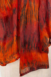 Tie dye silk scarf in shades of burnt orange, deep red and bronze.