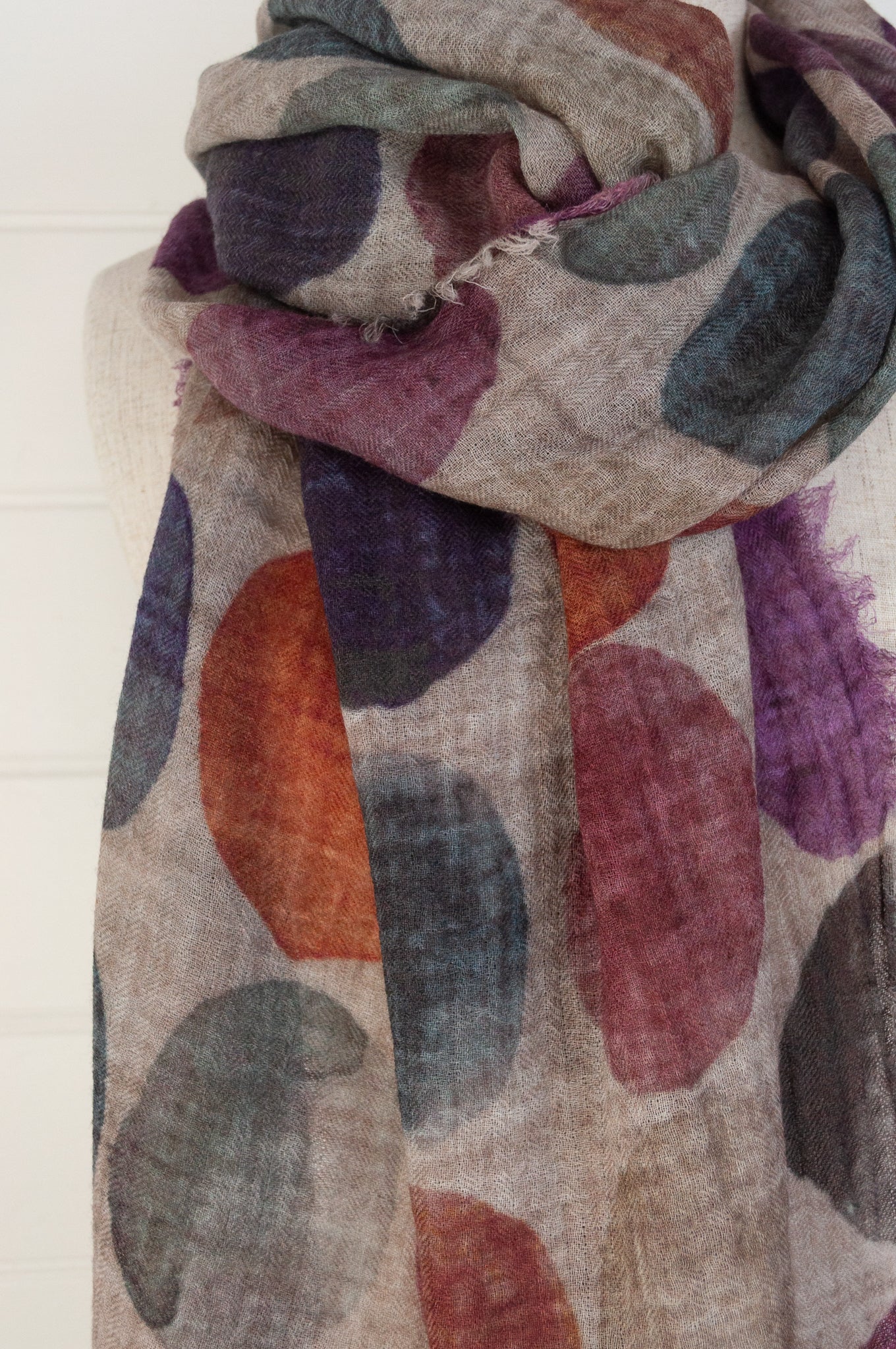 Juniper Hearth fine wool and modal scarf with multi coloured large dots on a beige background.