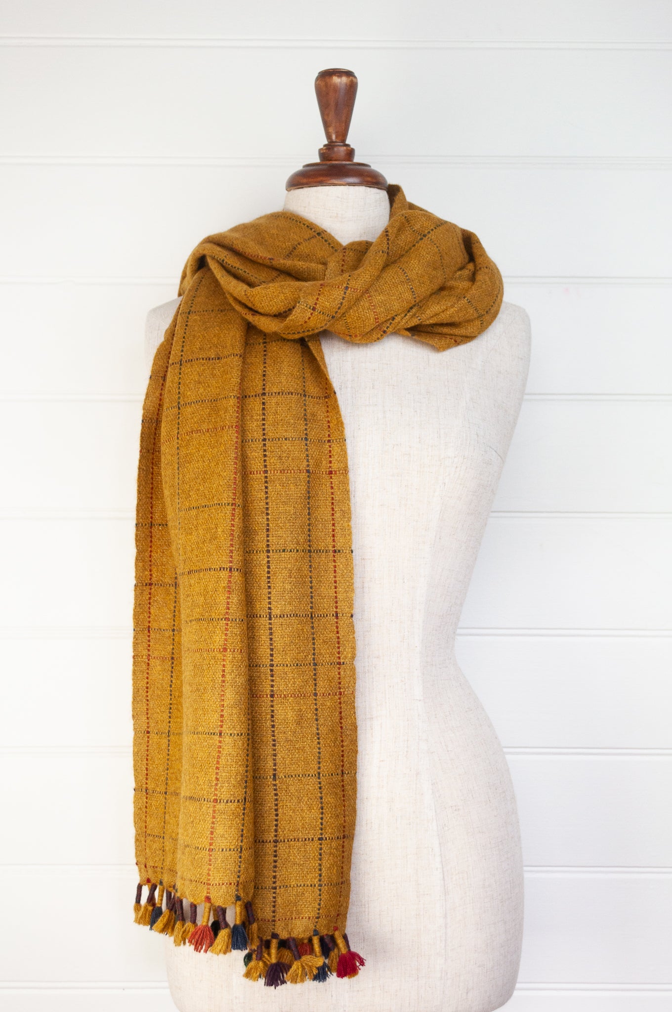 Juniper Hearth handwoven baby yak scarf with hand finished details and rainbow tassels in mustard yellow.