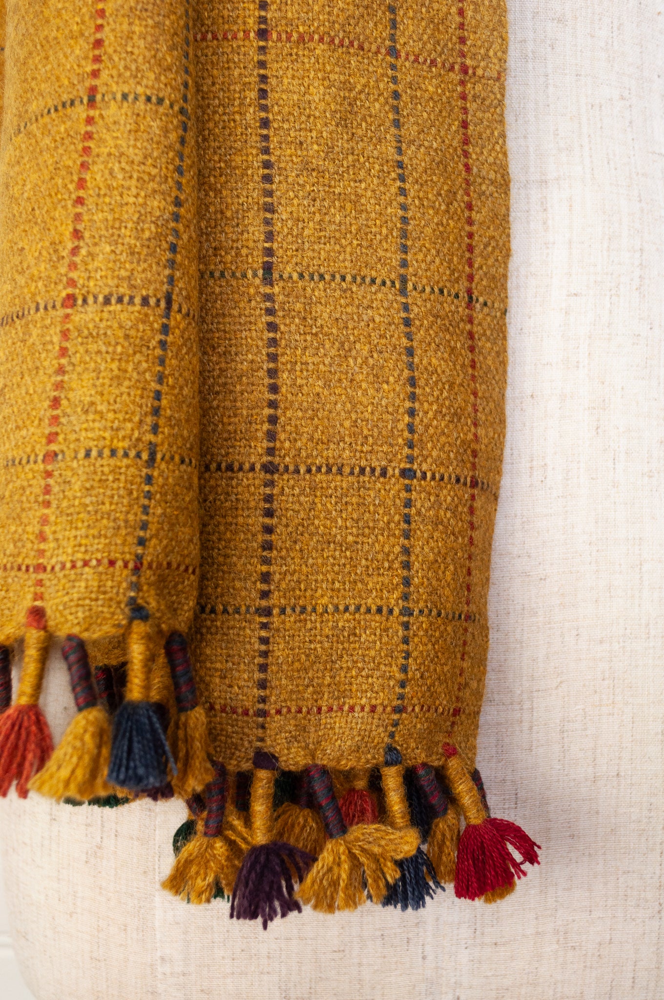 Juniper Hearth handwoven baby yak scarf with hand finished details and rainbow tassels in mustard yellow.