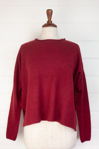 Baby yak sweater with round neck and side slits in cherry red.