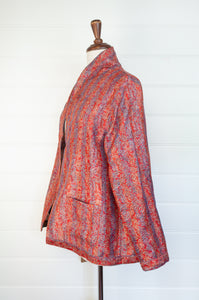 DVE Collection vintage silk kantha reversible Neeli jacket has a traditional paisley print on red on one side, and two emblem prints on the reverse.