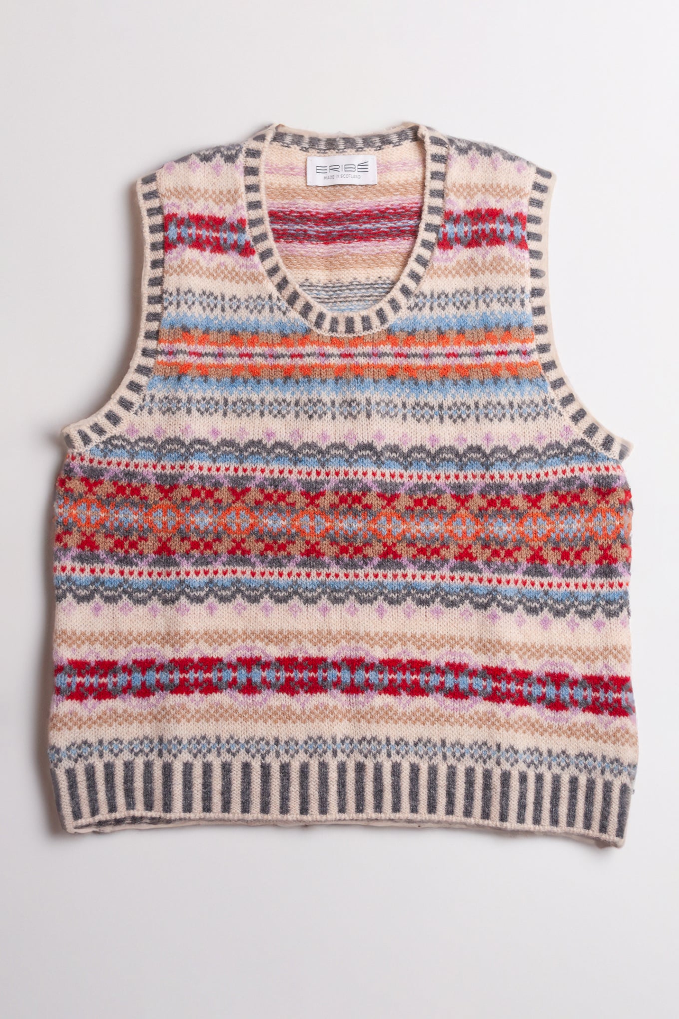 Eribe Westray fairisle vest in Mallaig, ecru, orange, crimson and sky blue.