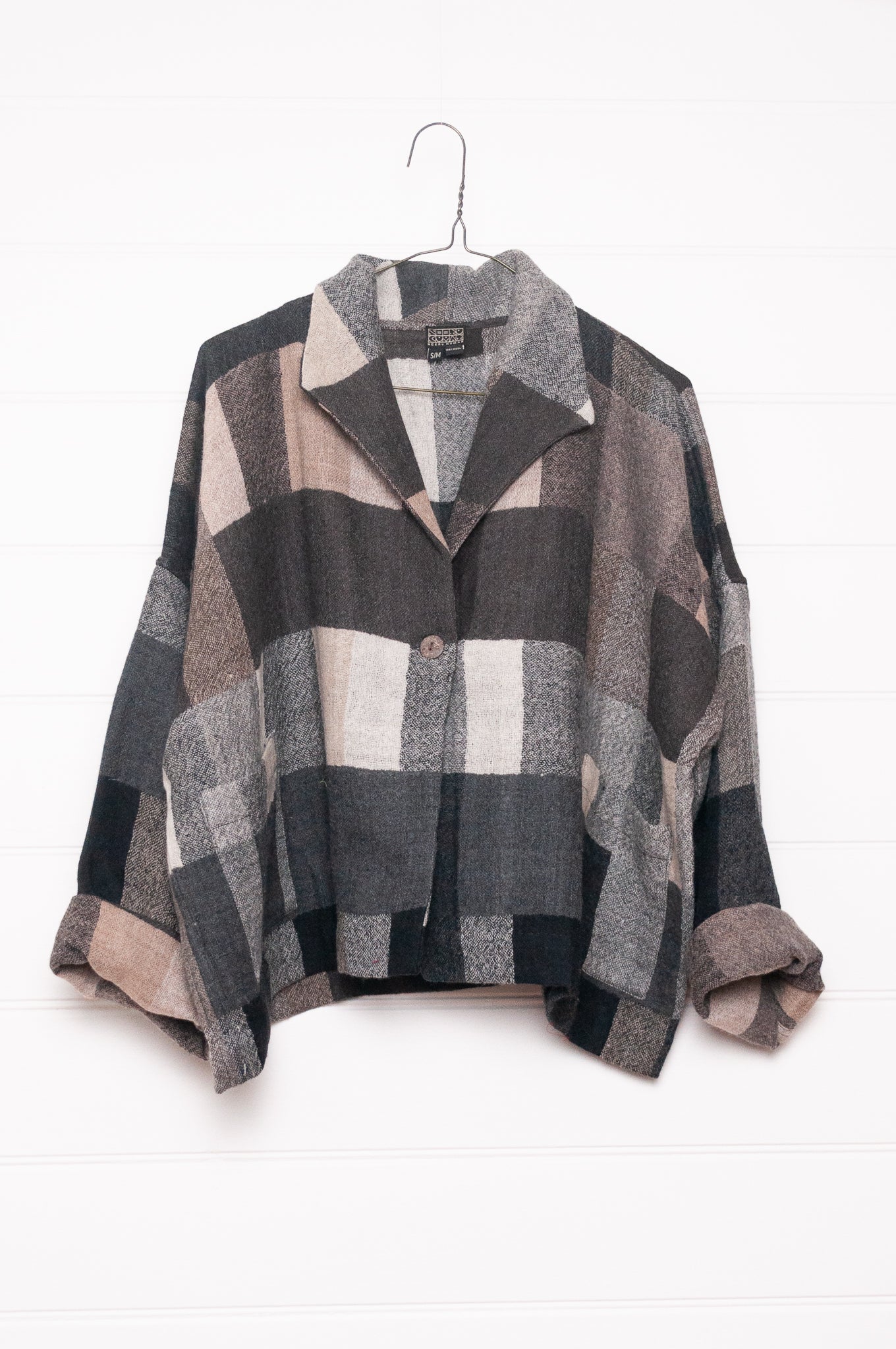 Neeru Kumar Coco jacket in blanket check wool, monochrome tones of charcoal, black, beige, latte and brown.