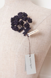 Classic Sophie Digard wool embroidered flower brooch Alpine in dark aubergine.