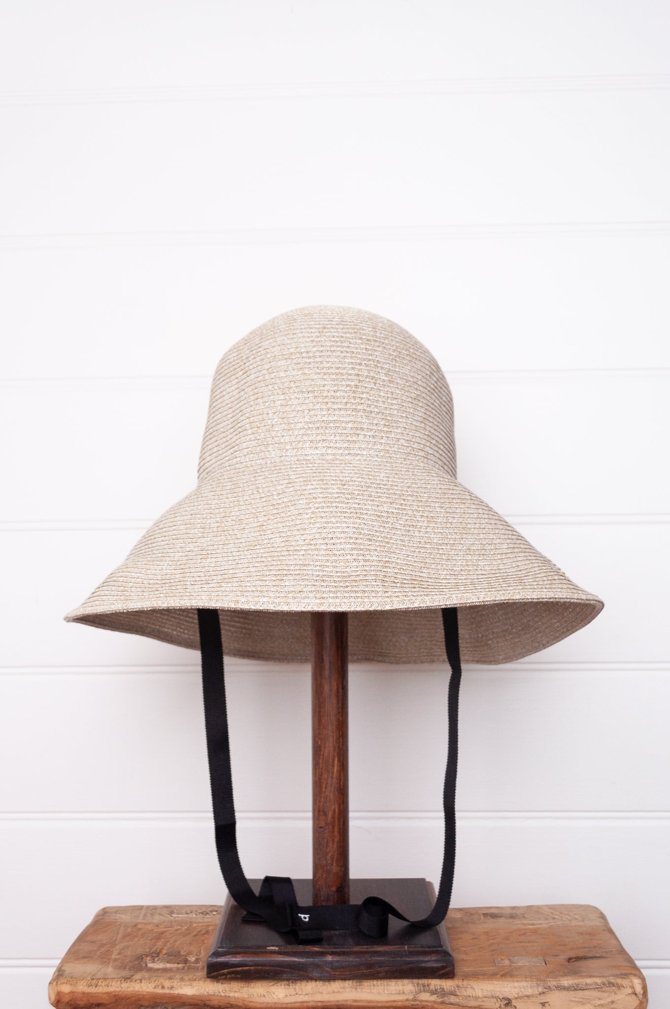 PCNQ made in Japan Leonie foldable paper hat in light grey with black ribbon.