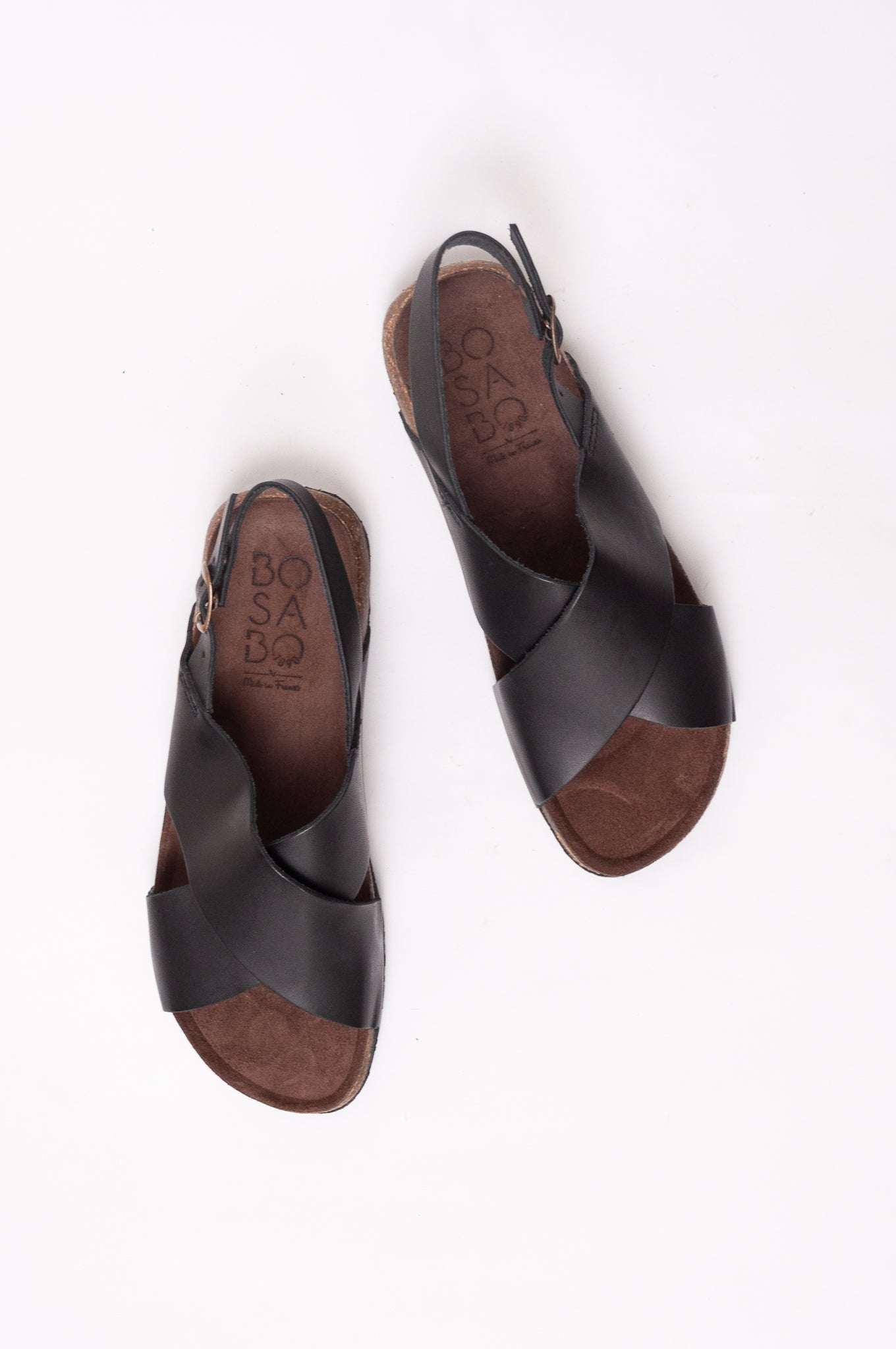 Bosasbo handmade in France cross over slides with molded cork footbed and black calf leather upper with strap and bronze buckle.