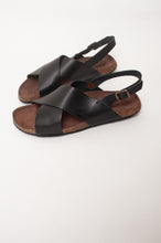 Load image into Gallery viewer, Bosasbo handmade in France cross over slides with molded cork footbed and black calf leather upper with strap and bronze buckle.