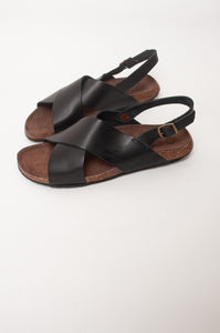 Bosasbo handmade in France cross over slides with molded cork footbed and black calf leather upper with strap and bronze buckle.