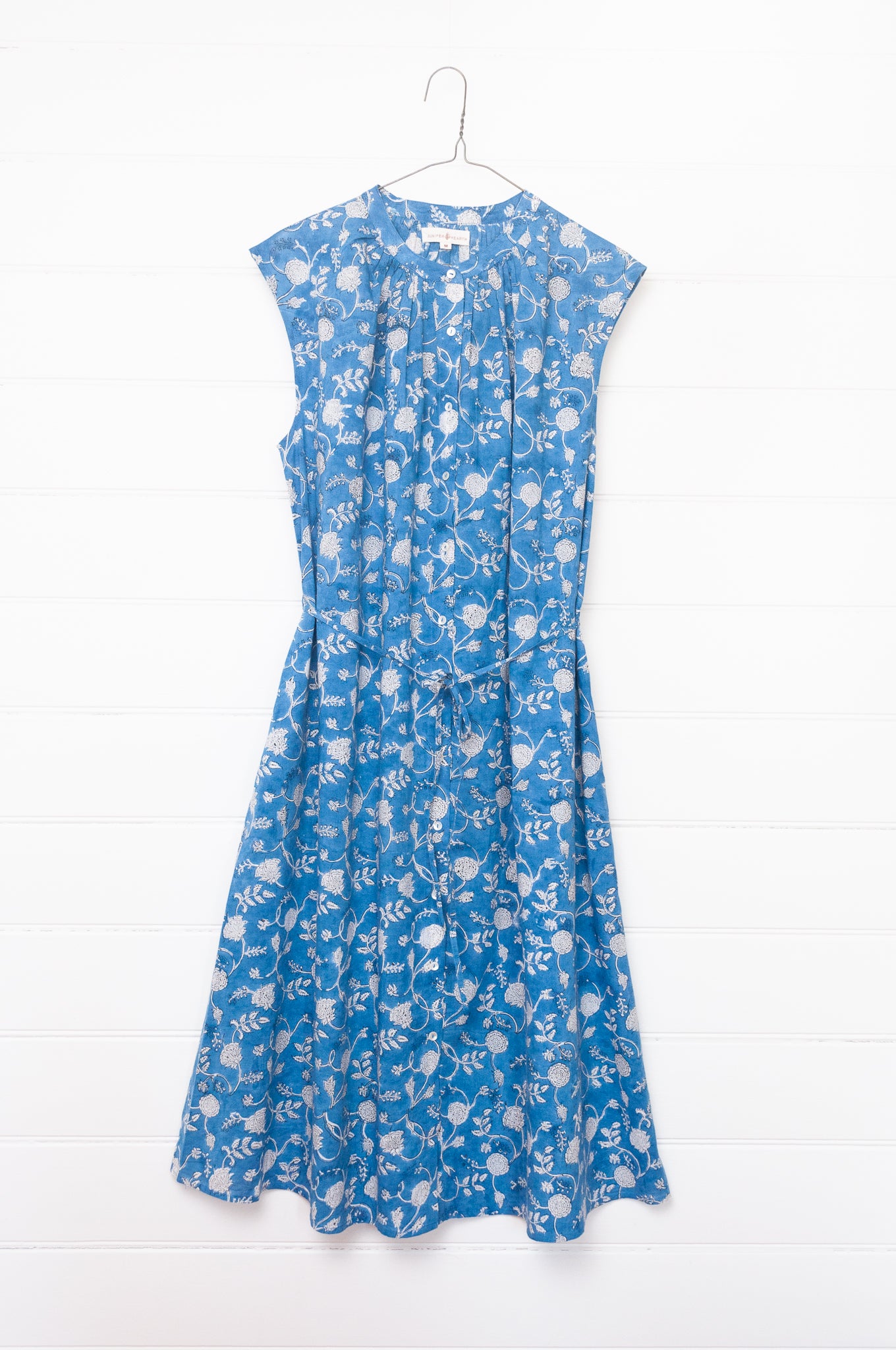 Juniper Hearth Zoe blockprint floral sleeveless cotton dress, buttonup with waist tie, in blue and white.