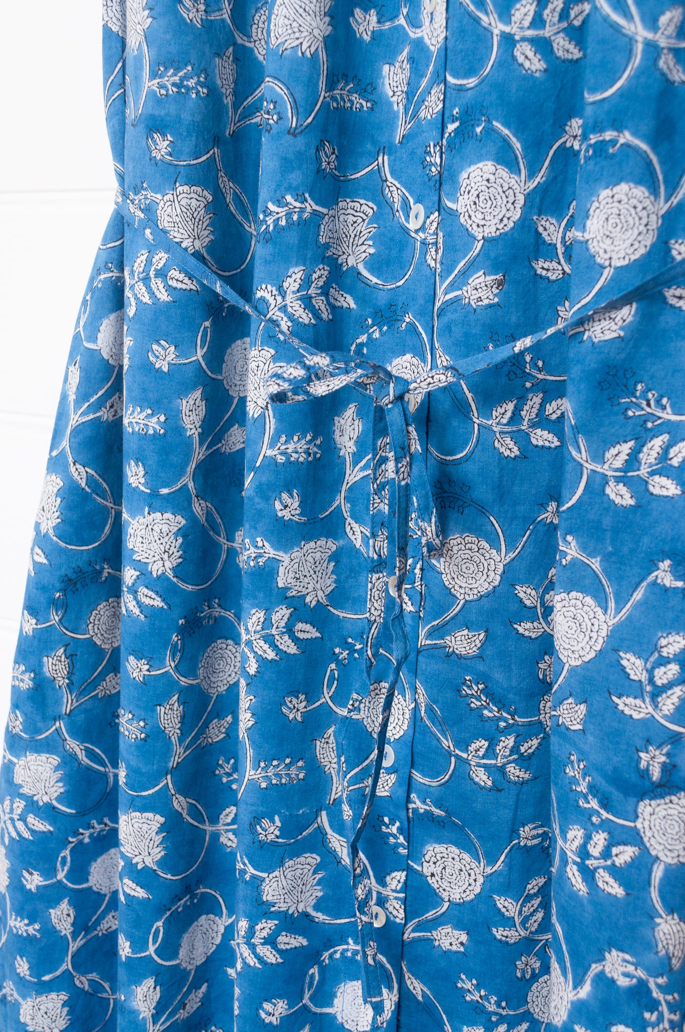 Juniper Hearth Zoe blockprint floral sleeveless cotton dress, buttonup with waist tie, in blue and white.