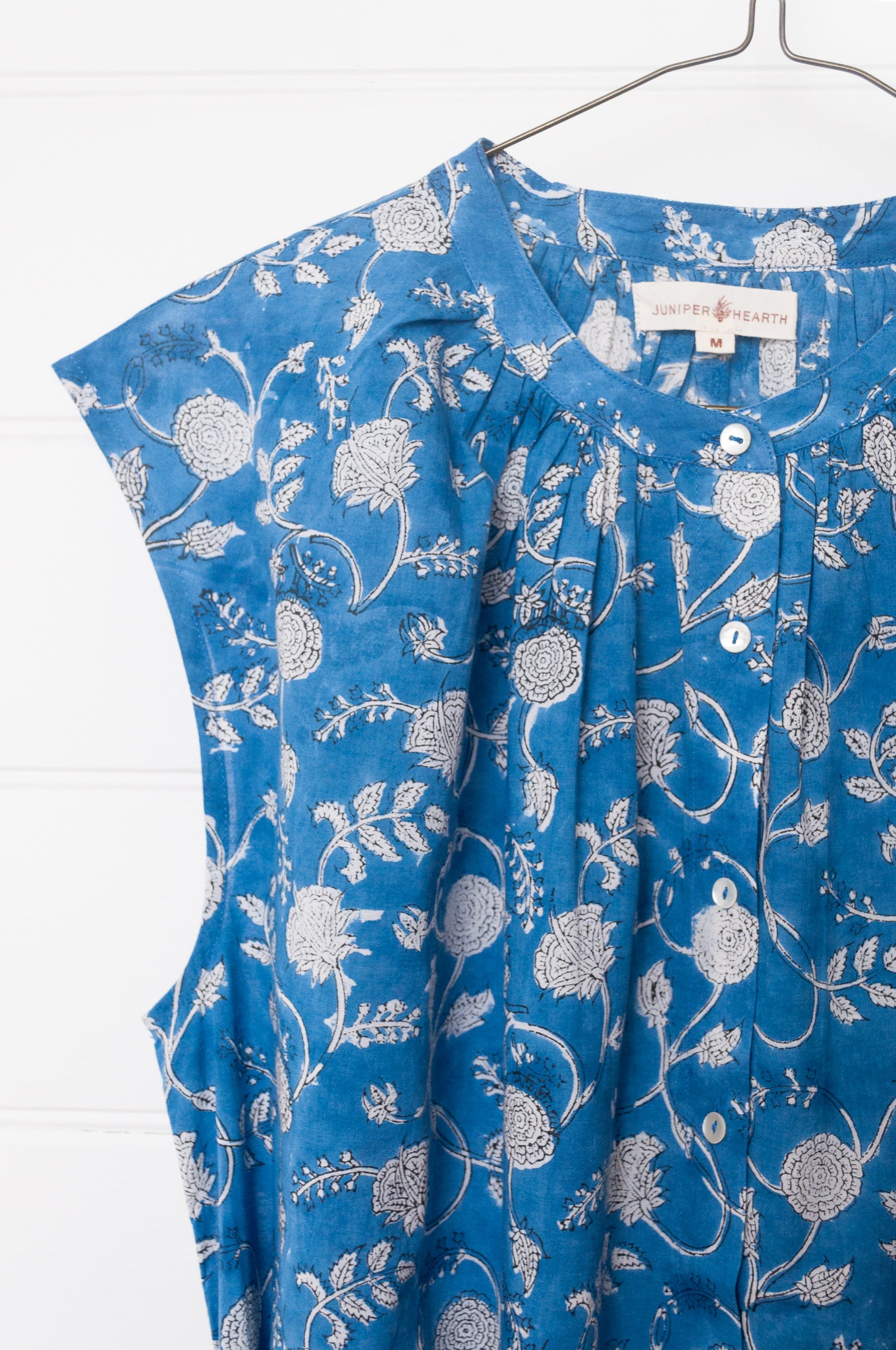 Juniper Hearth Zoe blockprint floral sleeveless cotton dress, buttonup with waist tie, in blue and white.