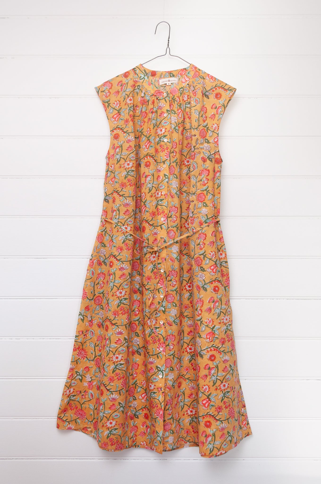 Juniper Hearth Zoe blockprint floral sleeveless cotton dress, buttonup with waist tie, in mustard yellow.