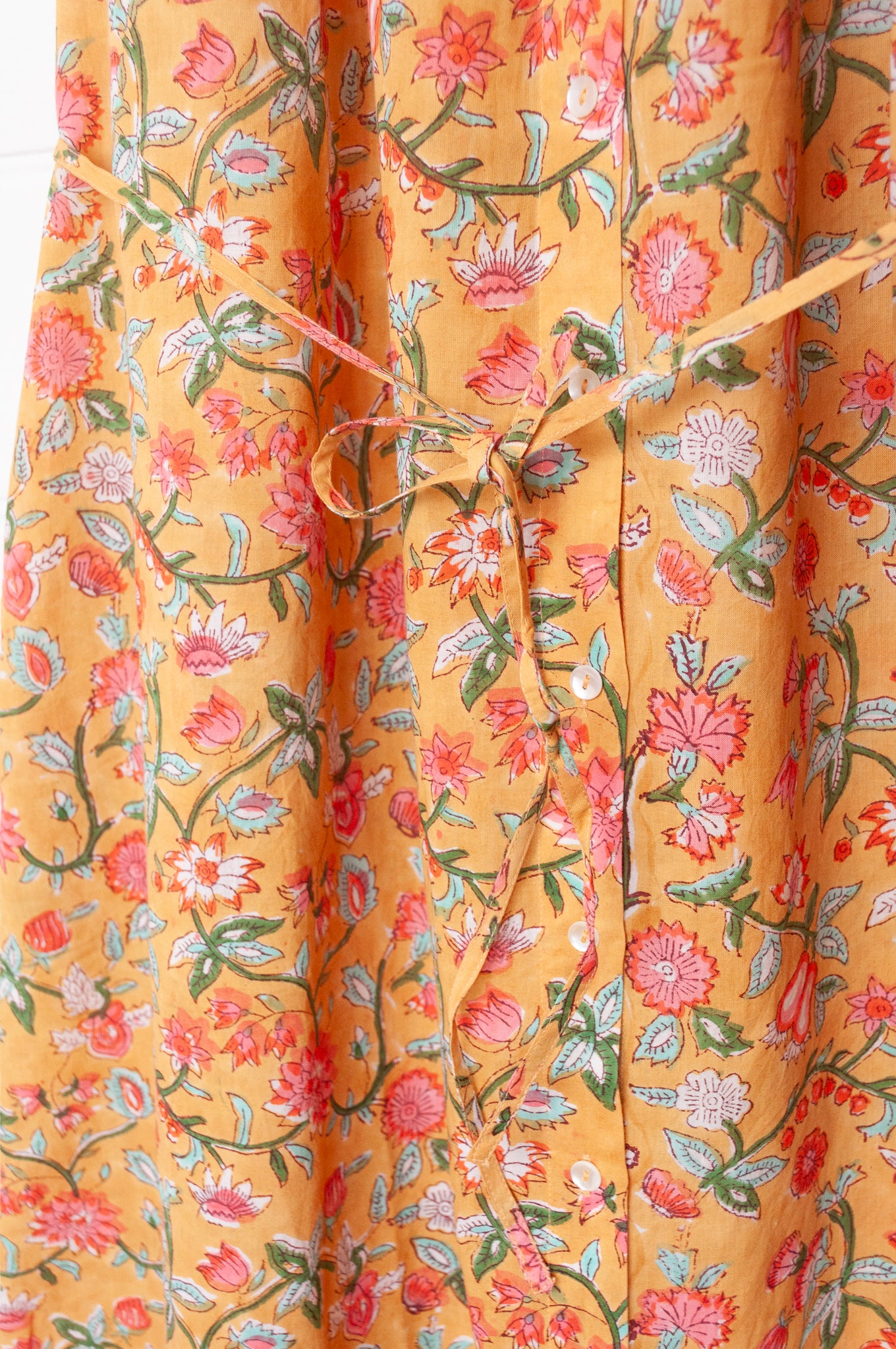 Juniper Hearth Zoe blockprint floral sleeveless cotton dress, buttonup with waist tie, in mustard yellow.
