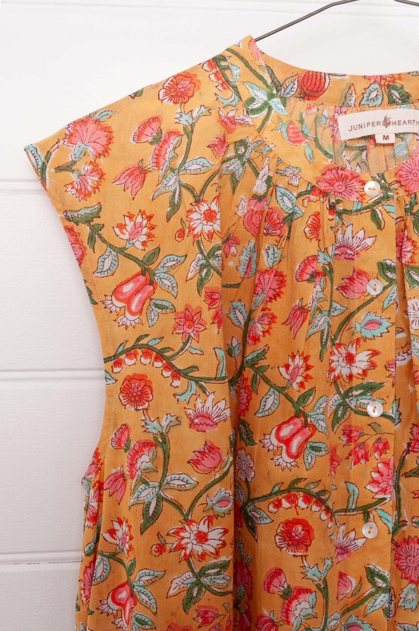 Juniper Hearth Zoe blockprint floral sleeveless cotton dress, buttonup with waist tie, in mustard yellow.