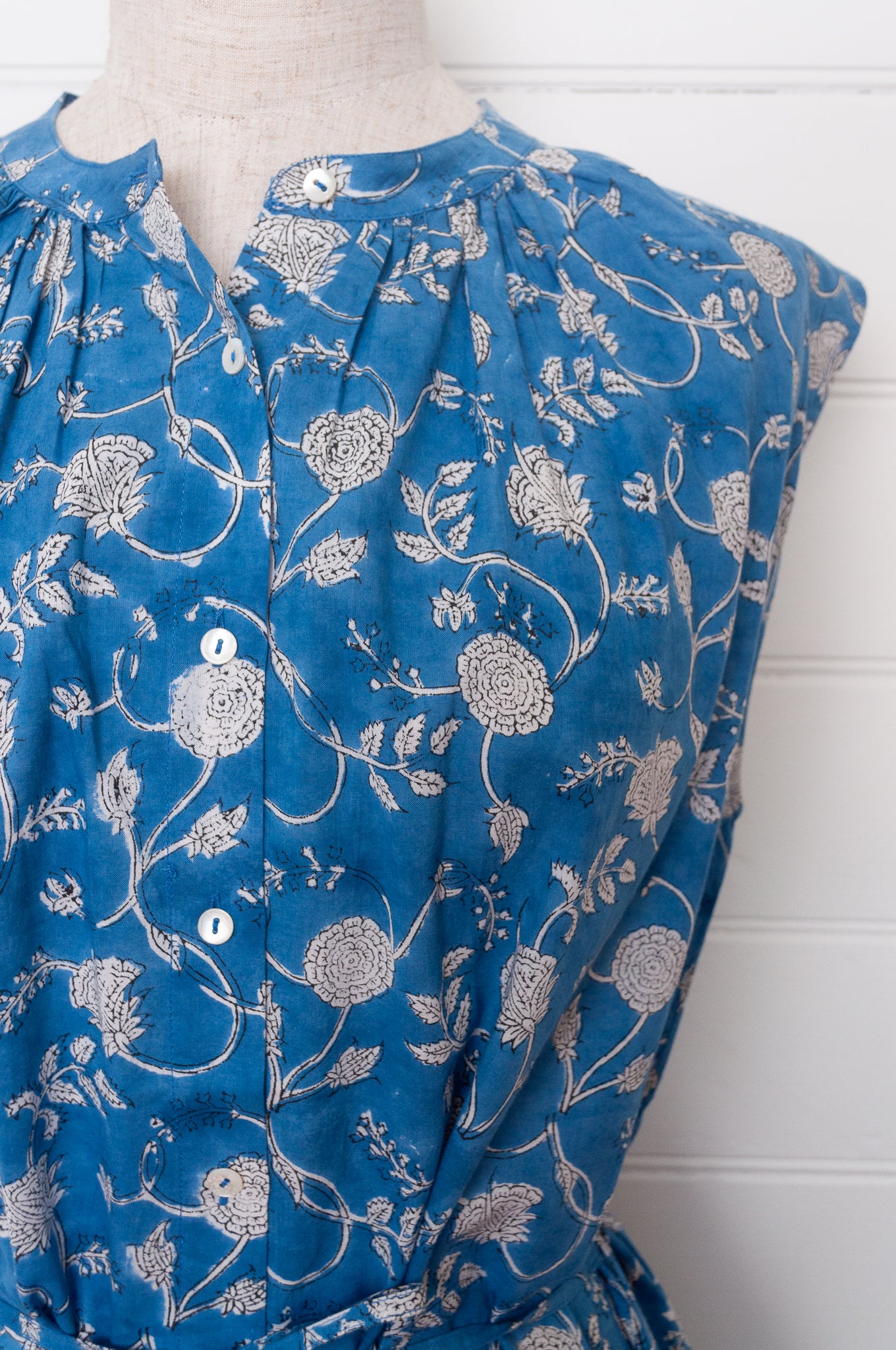 Juniper Hearth Zoe blockprint floral sleeveless cotton dress, buttonup with waist tie, in blue and white.