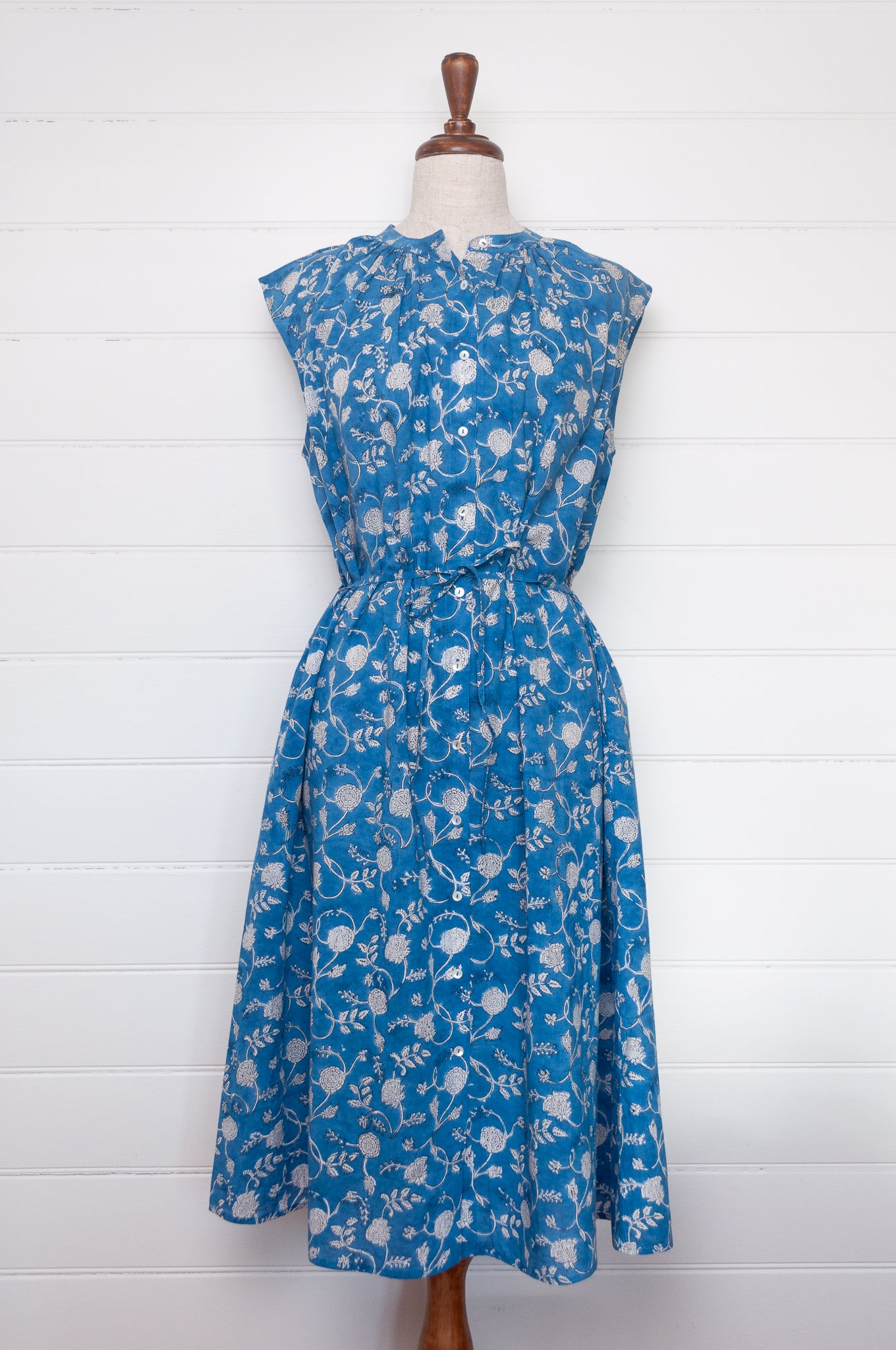 Juniper Hearth Zoe blockprint floral sleeveless cotton dress, buttonup with waist tie, in blue and white.