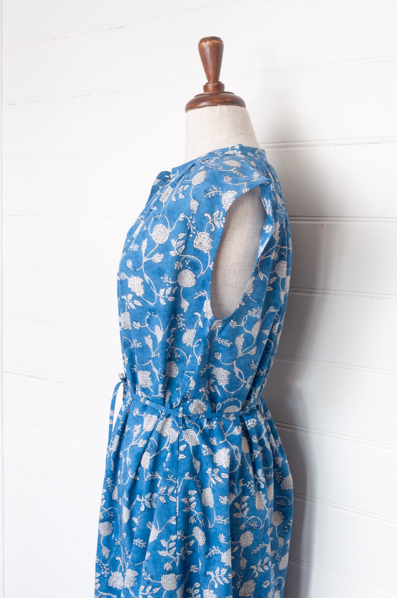 Juniper Hearth Zoe blockprint floral sleeveless cotton dress, buttonup with waist tie, in blue and white.