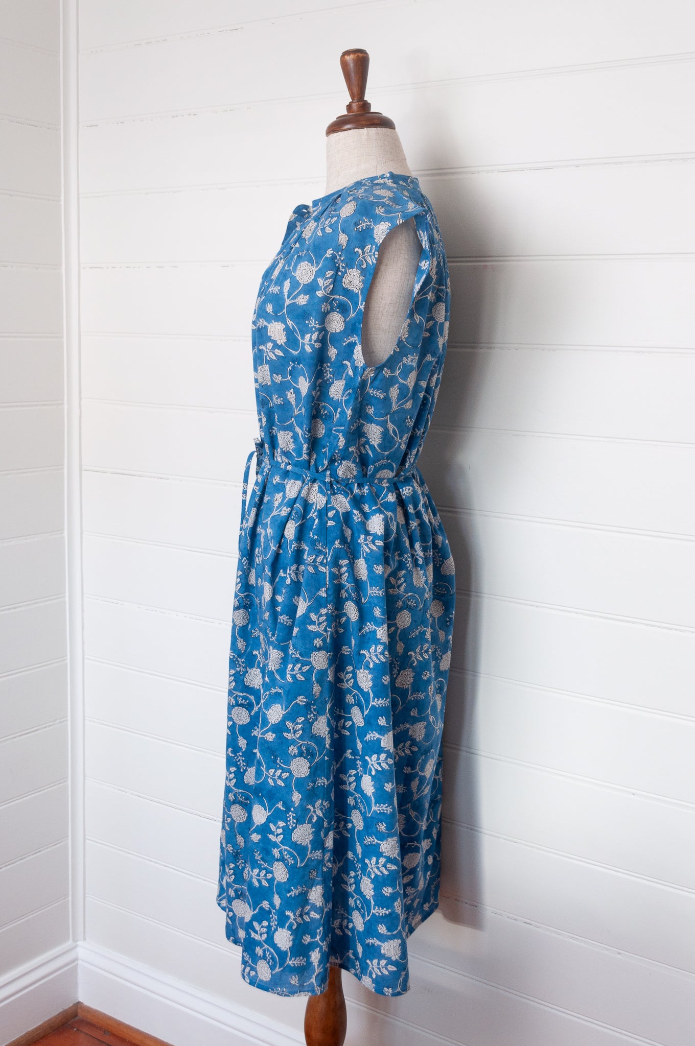 Juniper Hearth Zoe blockprint floral sleeveless cotton dress, buttonup with waist tie, in blue and white.