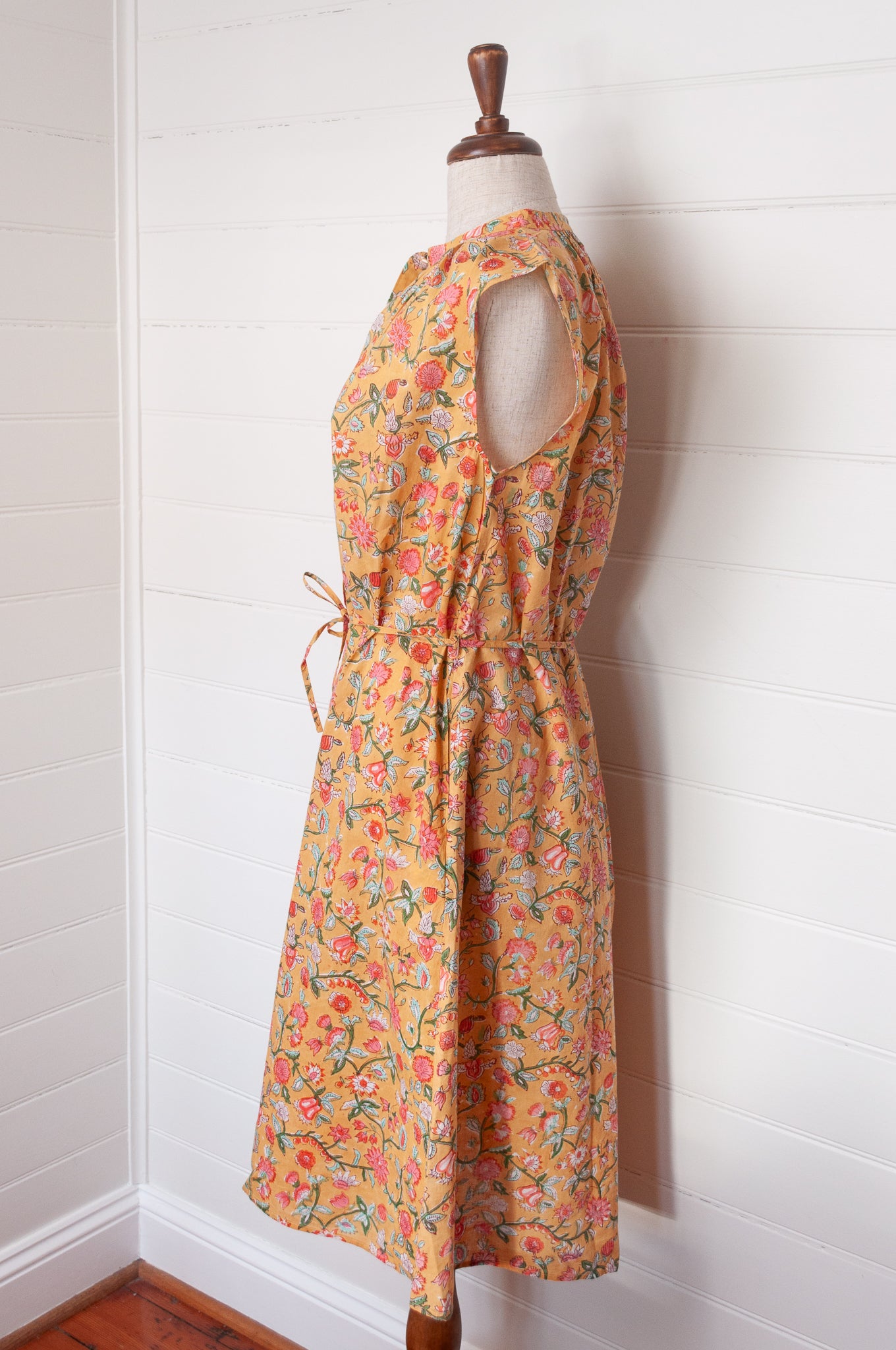 Juniper Hearth Zoe blockprint floral sleeveless cotton dress, buttonup with waist tie, in mustard yellow.