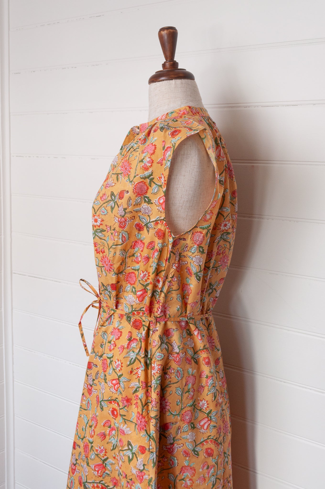 Juniper Hearth Zoe blockprint floral sleeveless cotton dress, buttonup with waist tie, in mustard yellow.