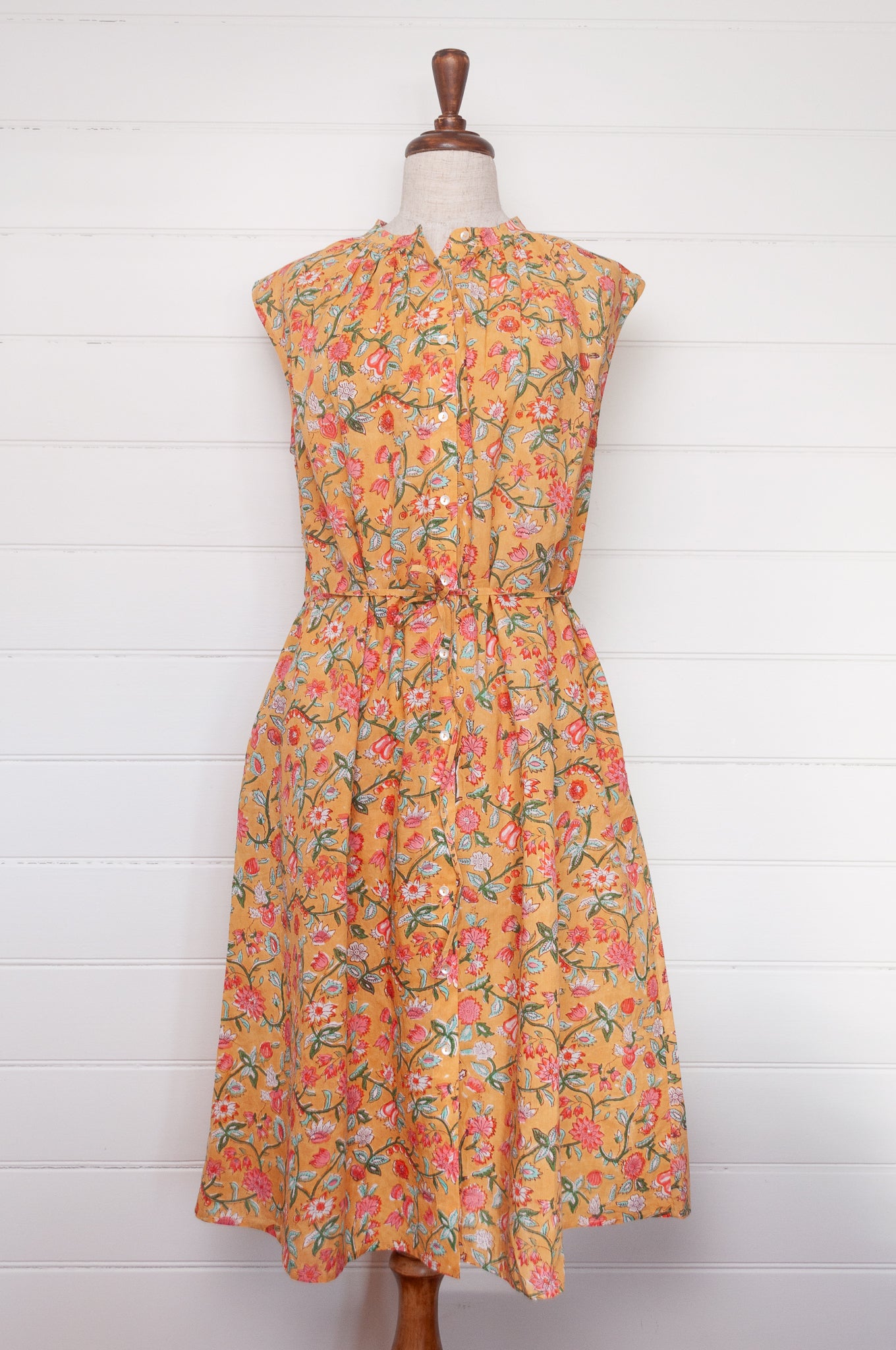 Juniper Hearth Zoe blockprint floral sleeveless cotton dress, buttonup with waist tie, in mustard yellow.