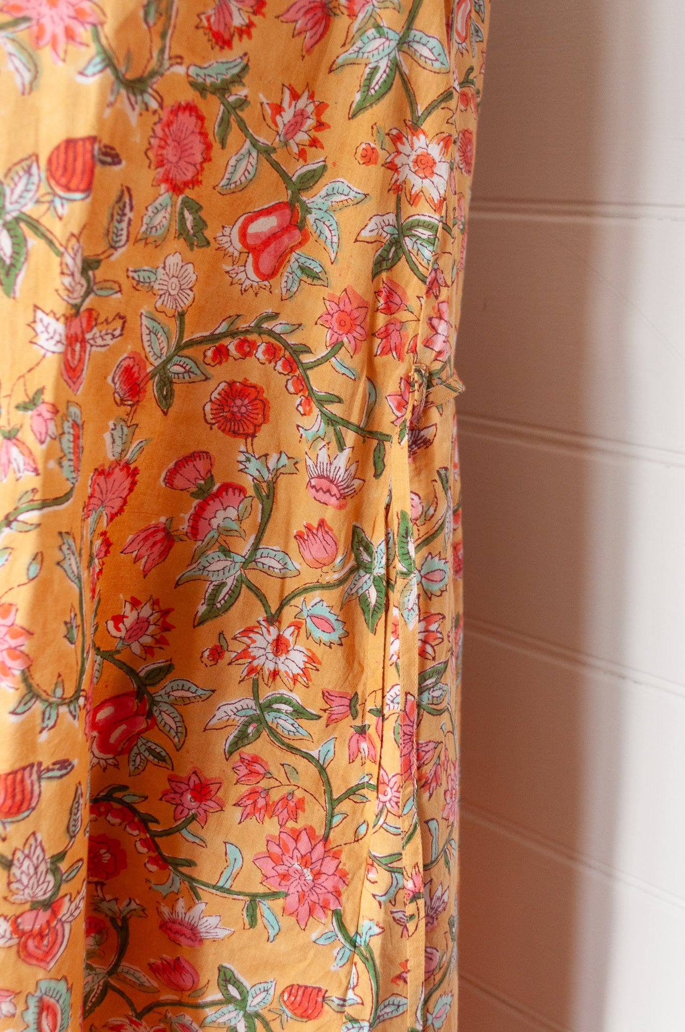 Juniper Hearth Zoe blockprint floral sleeveless cotton dress, buttonup with waist tie, in mustard yellow.