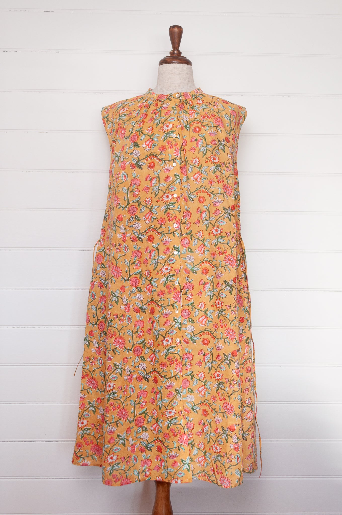 Juniper Hearth Zoe blockprint floral sleeveless cotton dress, buttonup with waist tie, in mustard yellow.