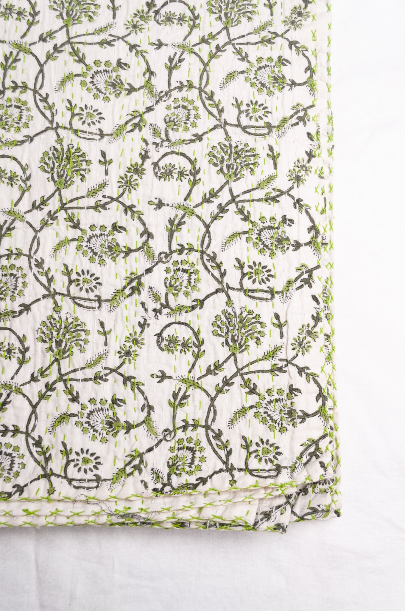Hand stitched block print pure cotton kantha quilt sage green floral and vine on white.