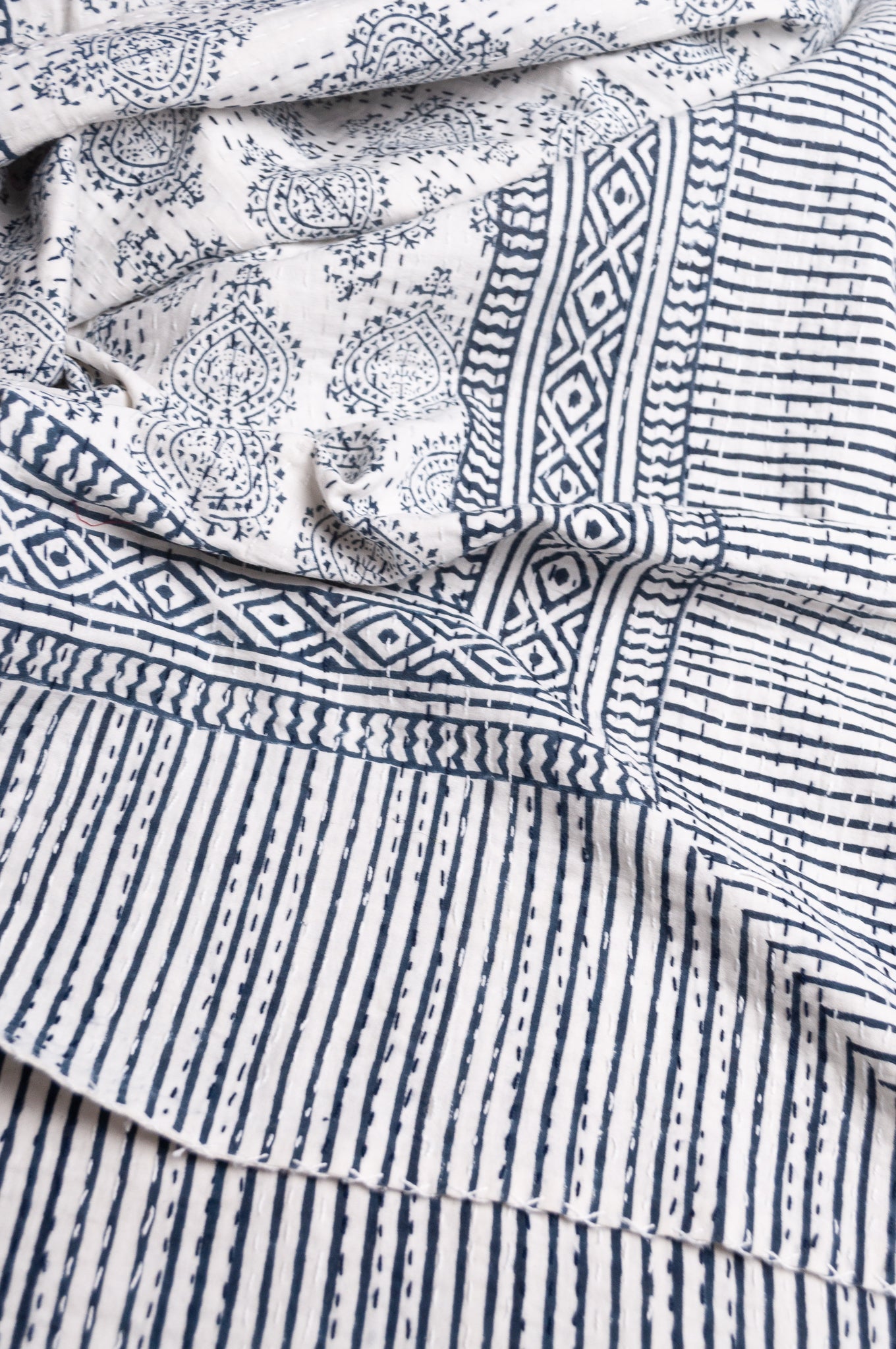 Blue and white mogul print cotton kantha quilt.