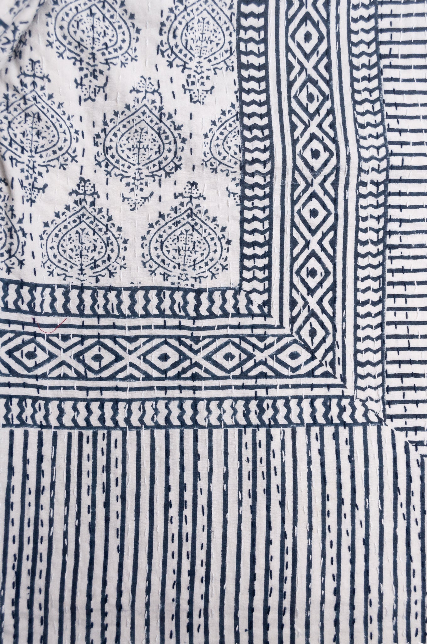 Blue and white mogul print cotton kantha quilt.